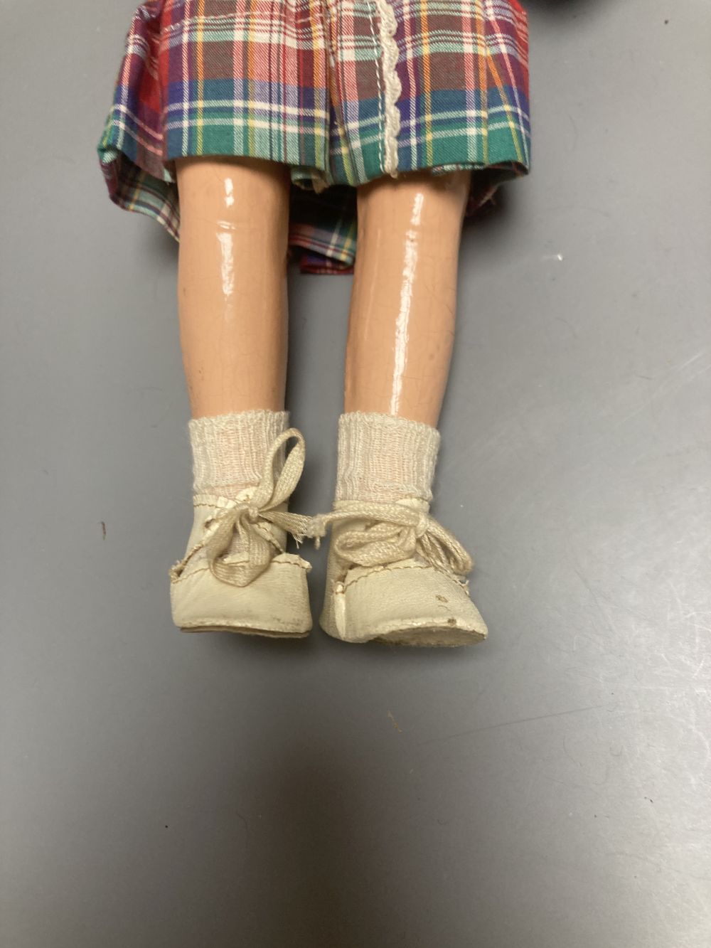An Armand Marseille bisque boy doll, mould 990 with fixed glass eyes, 30cm, a bisque doll with jointed composition body, 47cm and a pai